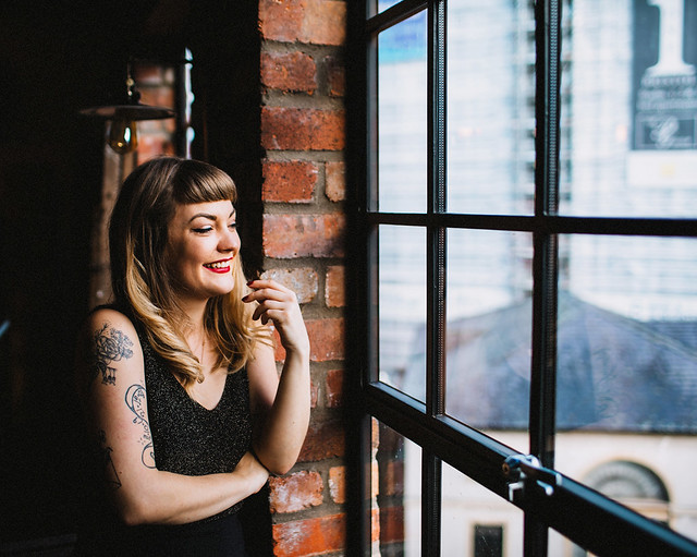 Lyzi Unwin at The Forge, Bristol. Photographed by Lauren Jayne Hall. lyzi unwin being little the forge bristol lauren jayne hall photographer tattoos rose rebecca vincent brick wall red lips