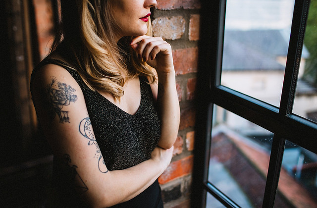 Lyzi Unwin at The Forge, Bristol. Photographed by Lauren Jayne Hall. lyzi unwin being little the forge bristol lauren jayne hall photographer tattoos rose rebecca vincent brick wall red lips